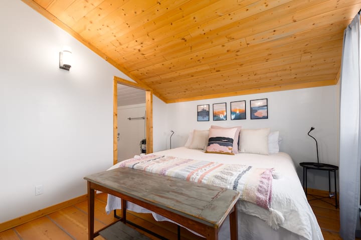 Top-floor king bedroom with attached ensuite (shower) bathroom and large north-facing window