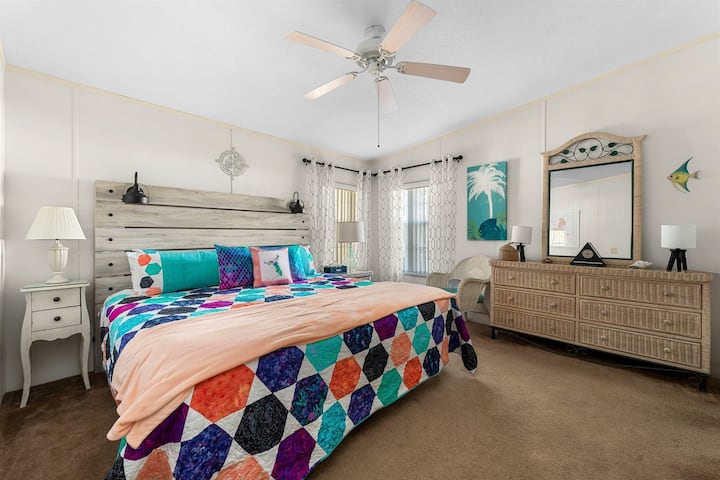 The primary bedroom features a king size bed, dresser, walk in closet, and TV with Roku.  The primary bath is also attached.