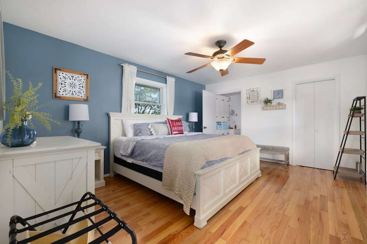 Wake up to the gentle sounds of the lake in this serene master bedroom.
