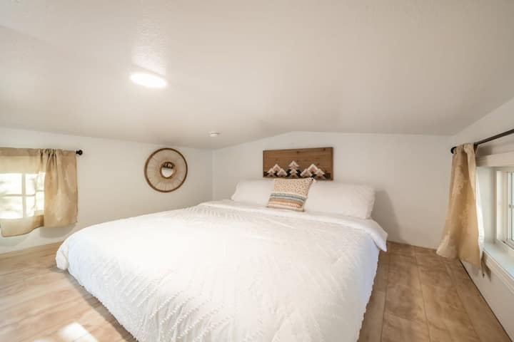 King Sized Bed with views of Pike's Peak located in the loft. (4.5 ft ceiling)