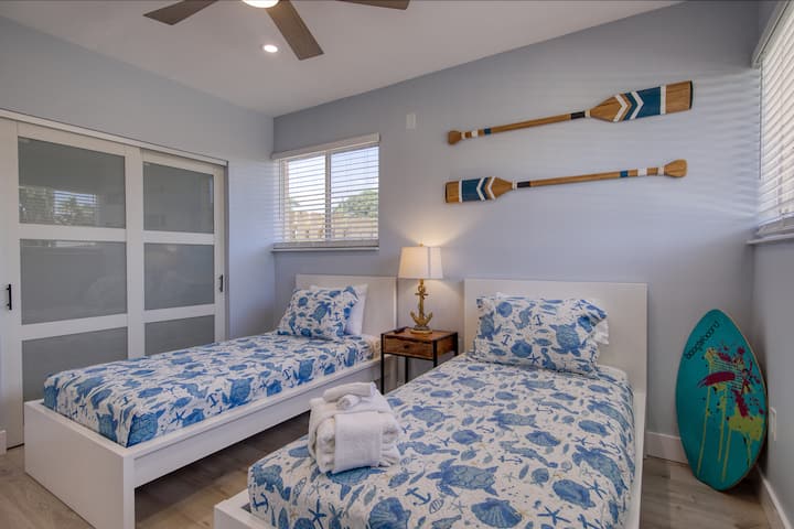 2 Single beds fun bedroom with TV and a door to outside