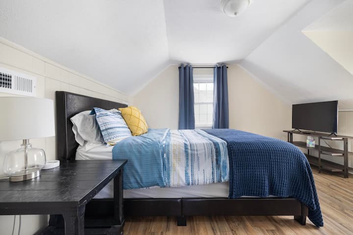 Enjoy restful nights in the upstairs queen bedroom, complete with a cozy and inviting atmosphere.