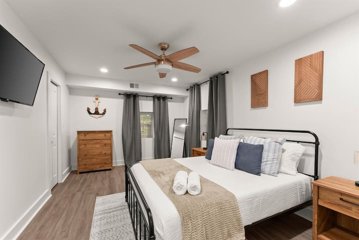 Roomy Queen bedroom downstairs with flat-screen TV.