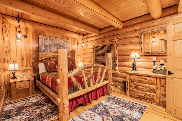 The master bedroom features a queen bed, 43in TV, and en-suite bathroom with closet.