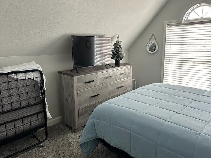 Queen bedroom #3 with additional rollaway bed that sleeps an additional guest.