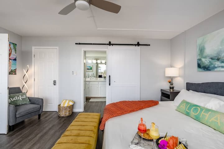 Extra seating in the Master Bedroom, and a sliding barn door that leads to an elegant bathroom and walk-in closet. 