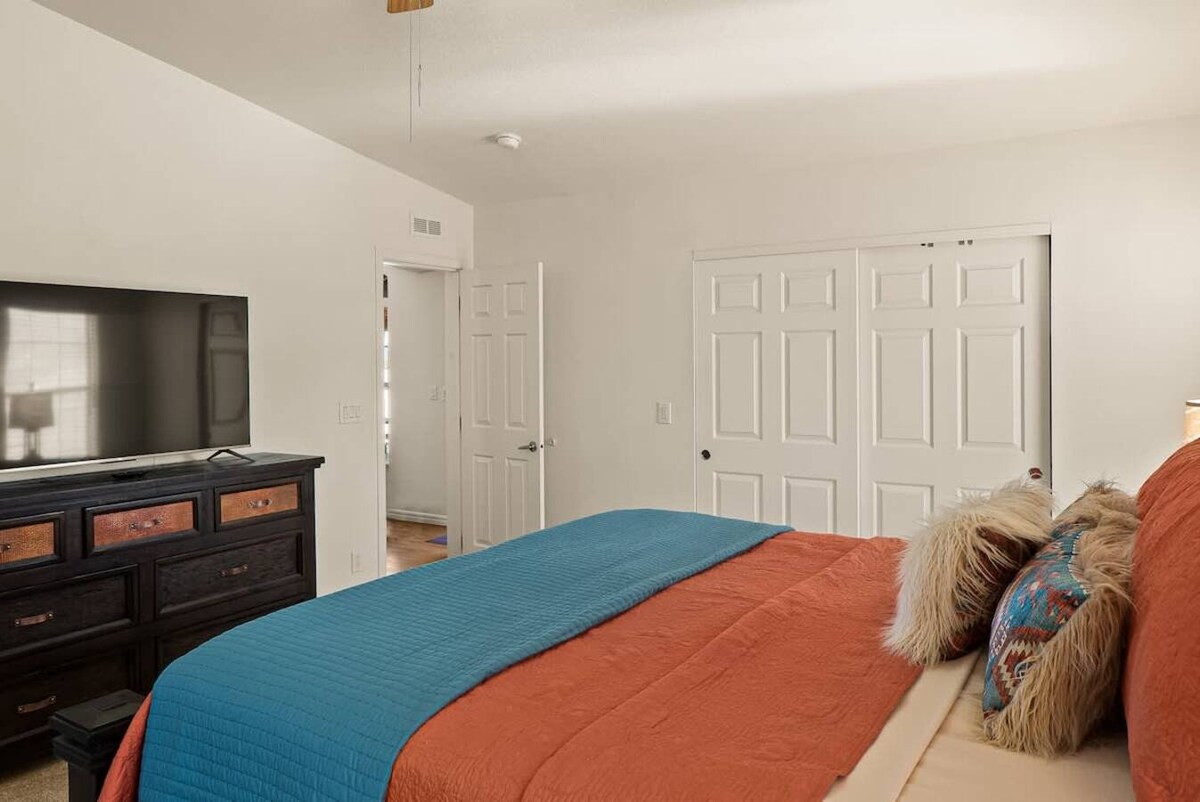 Master suite with dresser, closet space and TV that supports Roku.