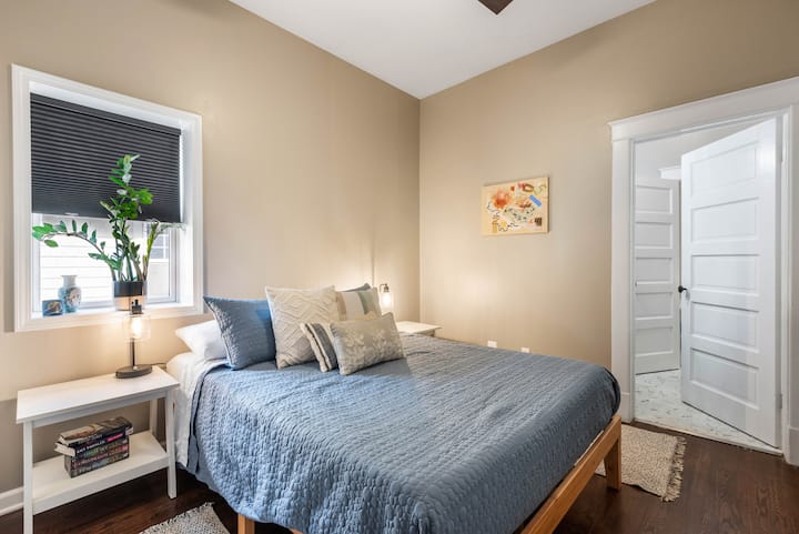 Cozy and calming queen bedroom with soft natural light—perfect for recharging after a full day exploring Kansas City.