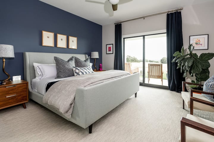 The primary bedroom with a King size bed opens out onto the front porch for a perfect morning coffee spot!