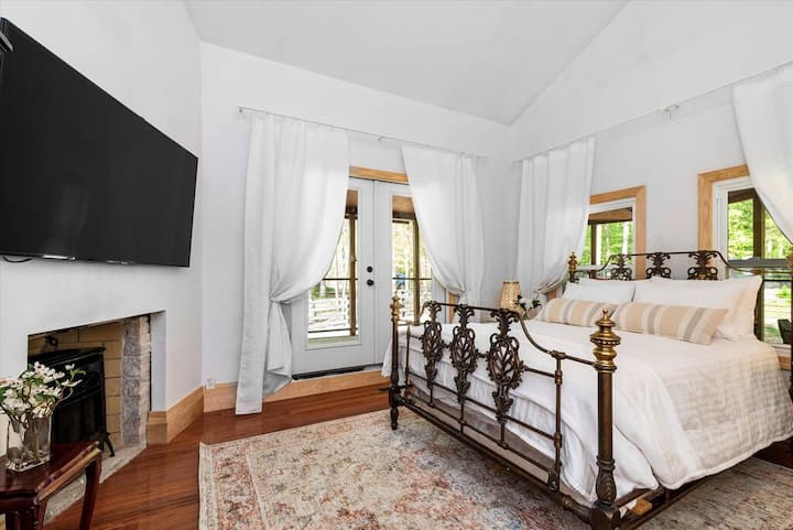 View of Coral Suite with Gas Fireplace. French Doors Open to Wrap Around Porch.