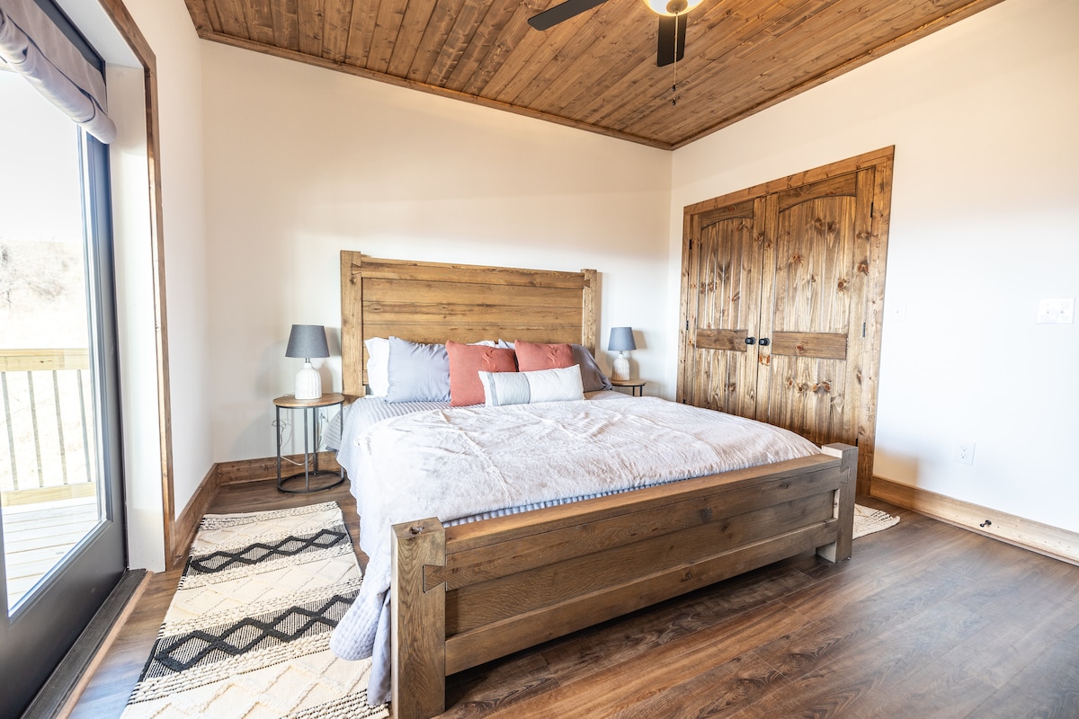 Second main floor bedroom with king bed and 50 inch TV.