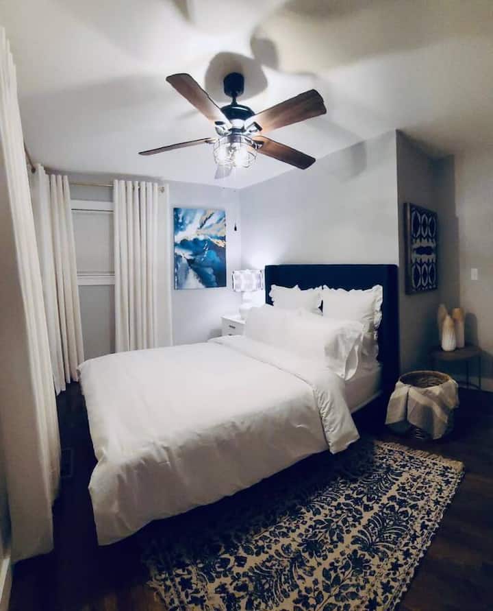 Comfortable queen bedroom with fresh linens, cozy bedding, and soft lighting for a restful night’s sleep.