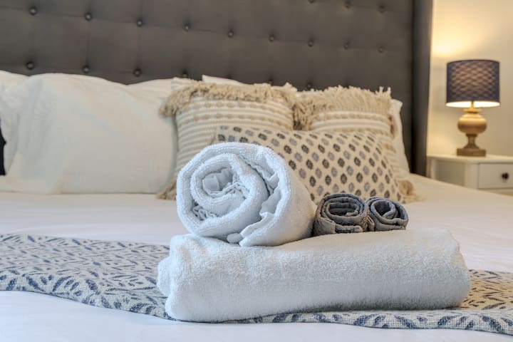 Large master bedroom featuring a King size bed and Smart TV with Firestick, and a sound machine. Large enough to set up a pack n play, which we provide in the closet.