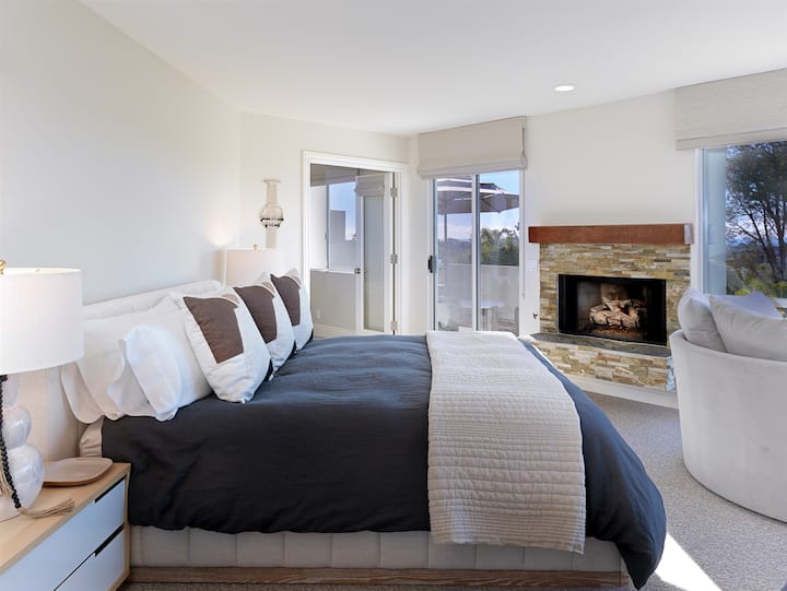 Main suite features fireplace and comfy bedding