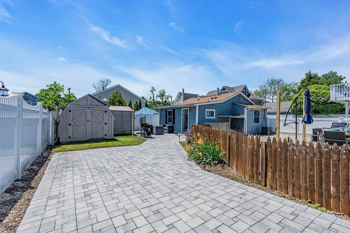 The paver patio and yard with room to relax and grill