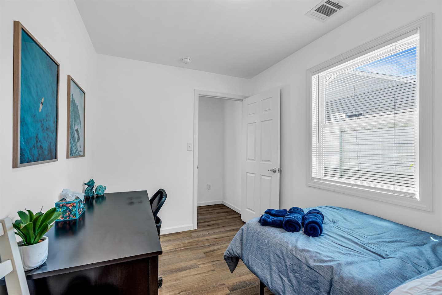 Picture the twin room doing double duty. Workspace by day, sleeper by night, natural light pouring through the side window.