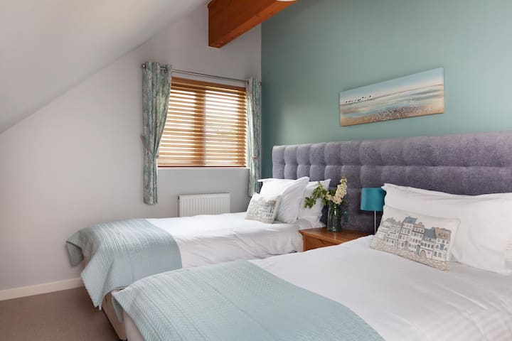 Dormitorio con dos camas individuales en el piso superior