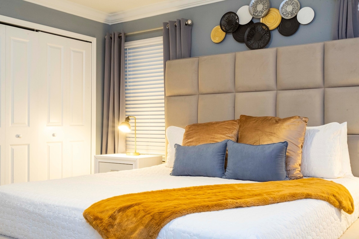 Master bedroom with a king size bed, walking closet and a smart TV