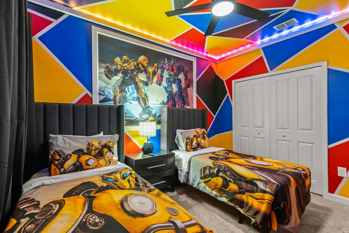 -变形金刚主题双床卧室，配有大胆的英雄壁画-明亮的彩色墙壁和大黄蜂床上用品，供孩子们享用-有趣的照明和装饰使这个房间令人兴奋和充满活力  