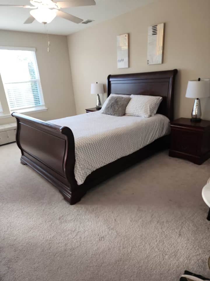 Spacious primary bedroom features queen bed, ample storage, walk-in closet, ensuite bathroom