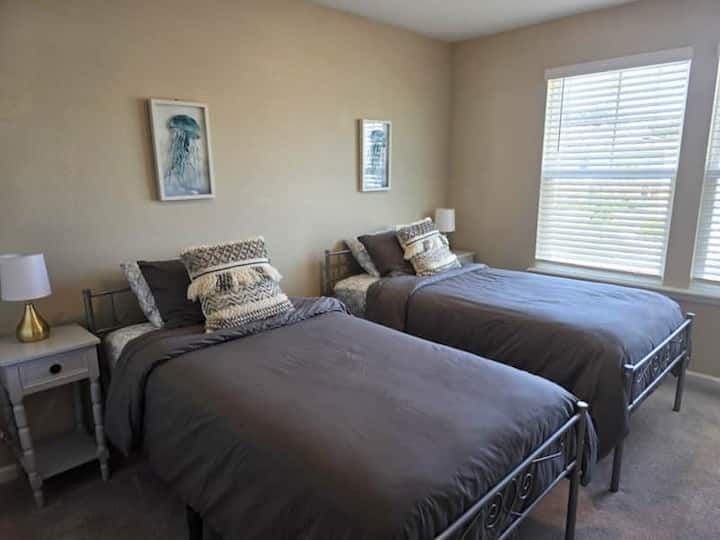 Comfortable, family-friendly twin bedroom includes smart tv, closet and extra storage 