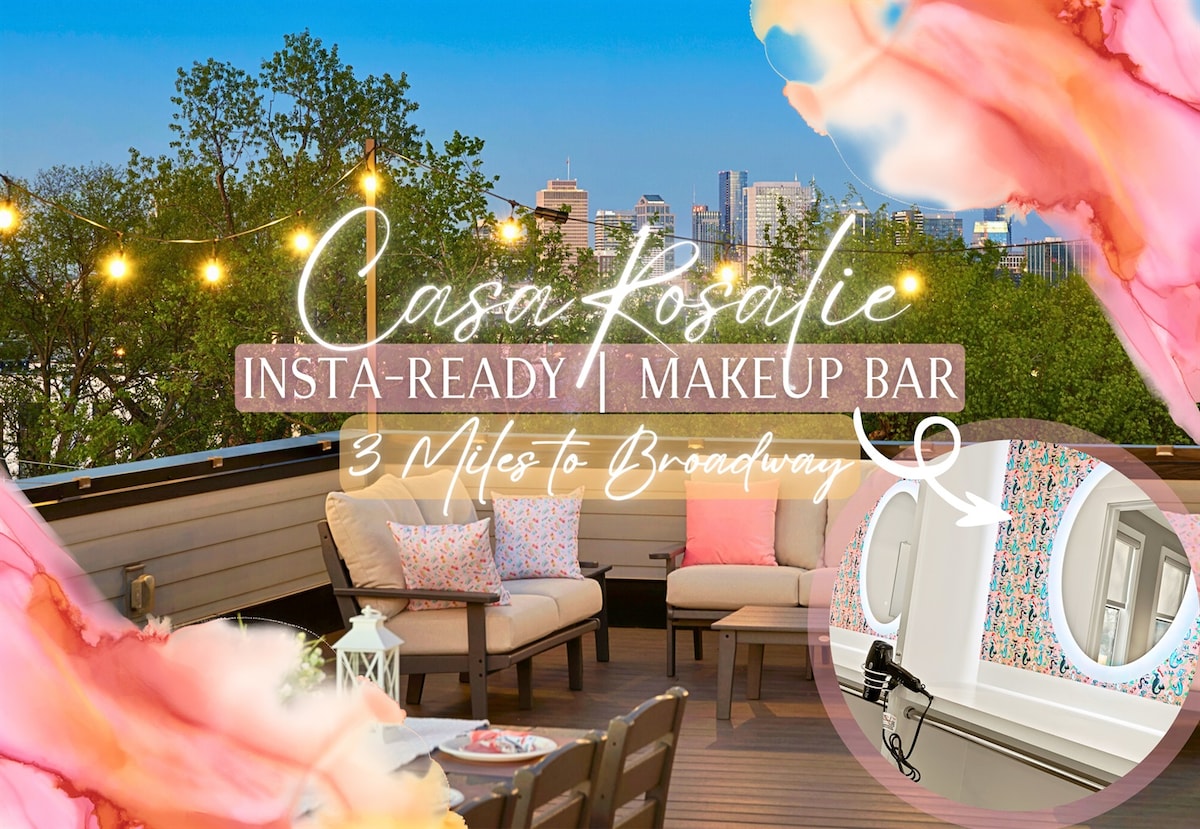 The rooftop terrace features an inviting setting with stylish outdoor furniture and soft lighting against a vibrant city skyline. A makeup bar with a floral design and a mirror offers a chic spot for preparing for outings. Decorative pillows enhance the cozy atmosphere.