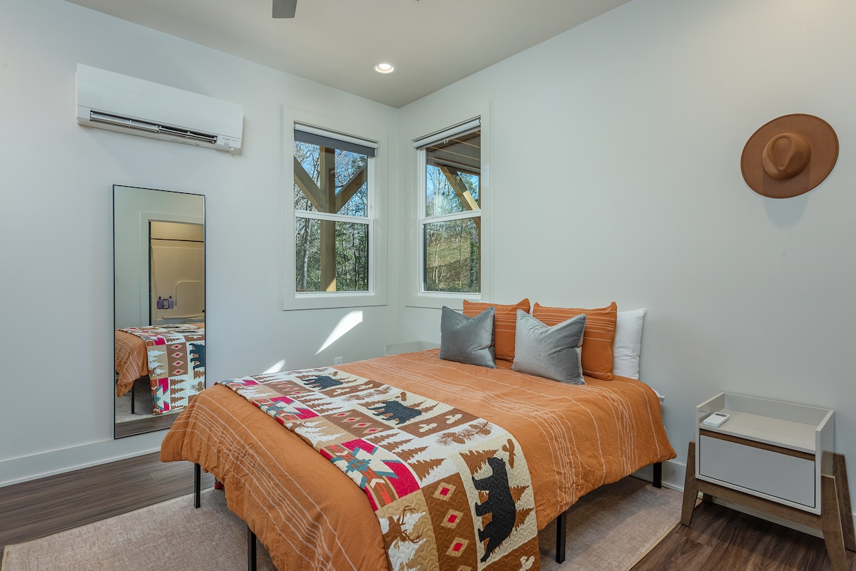 Forest Dreams: Lower-level bedroom with a comfy queen-size bed and the soft glow of natural light