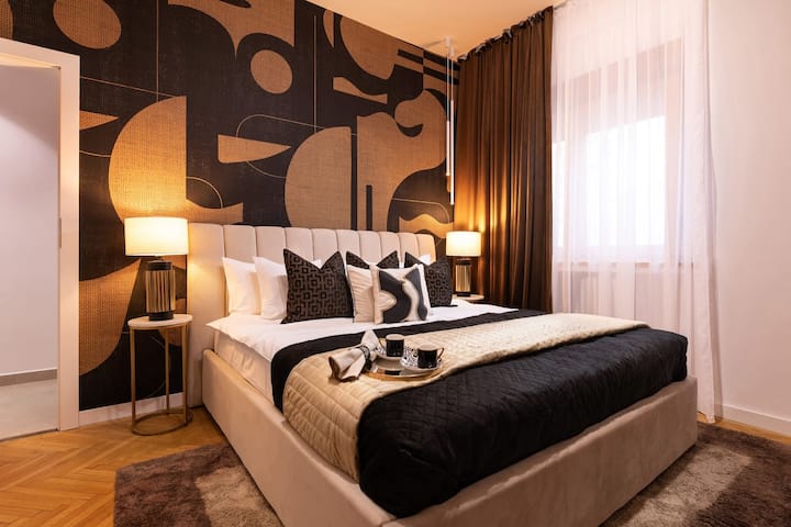 Enter a realm of modern luxury in our opulent bedroom, adorned with sleek black and radiant yellow gold accents for refined elegance.