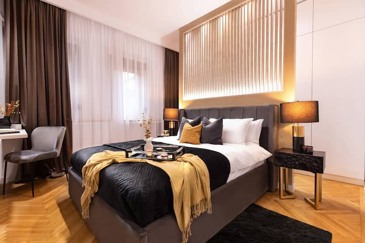 Immerse yourself in decadence in our modern bedroom, with bold black and warm yellow gold accents creating a sumptuous sanctuary.