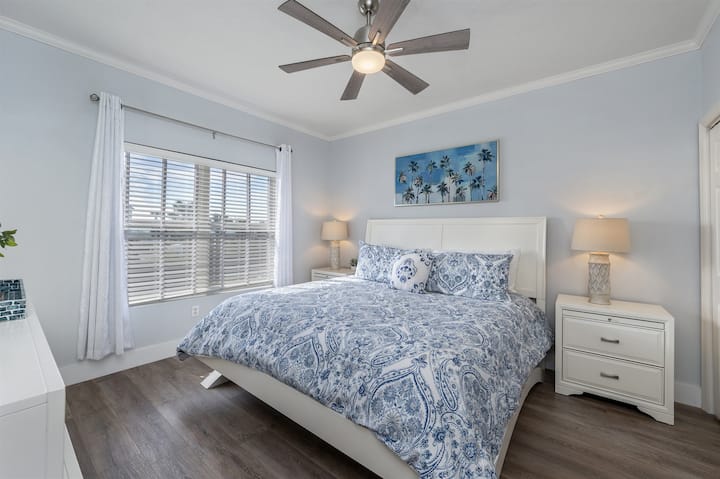 Master bedroom with king size bed and black out curtains.