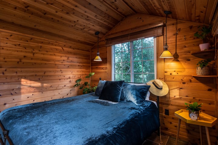 With a Queen bed and cozy wood interior.