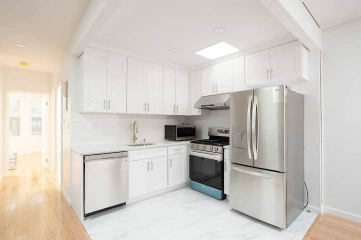 Kitchen with white cabinets and full-size appliances