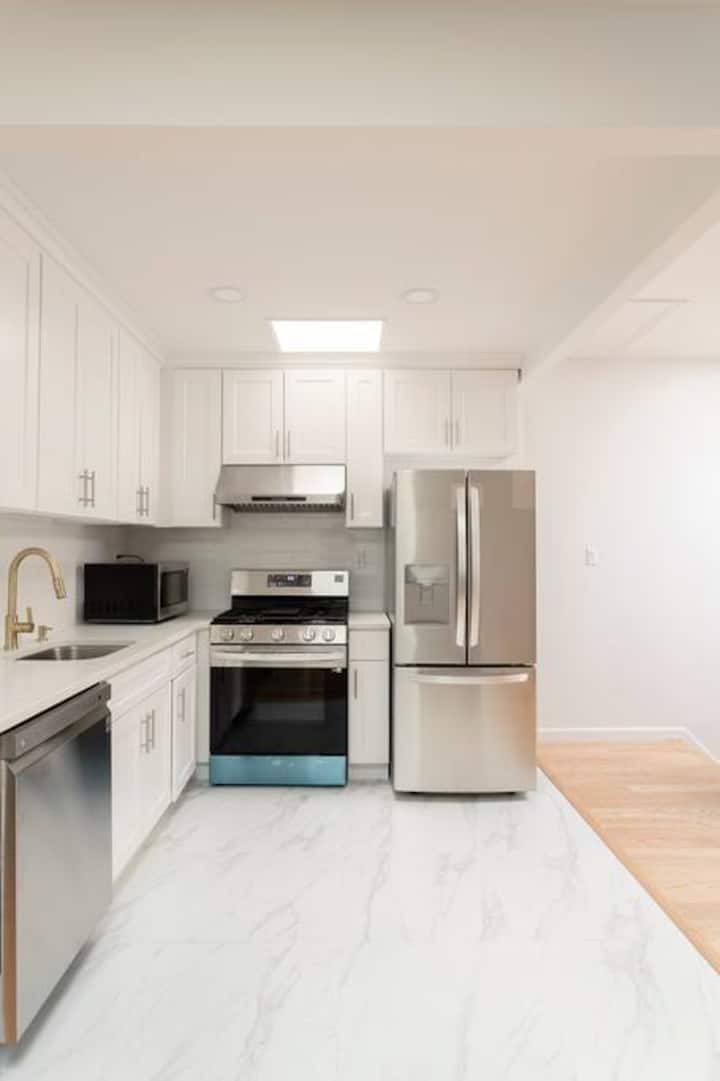 Kitchen with stainless appliances and marble floor