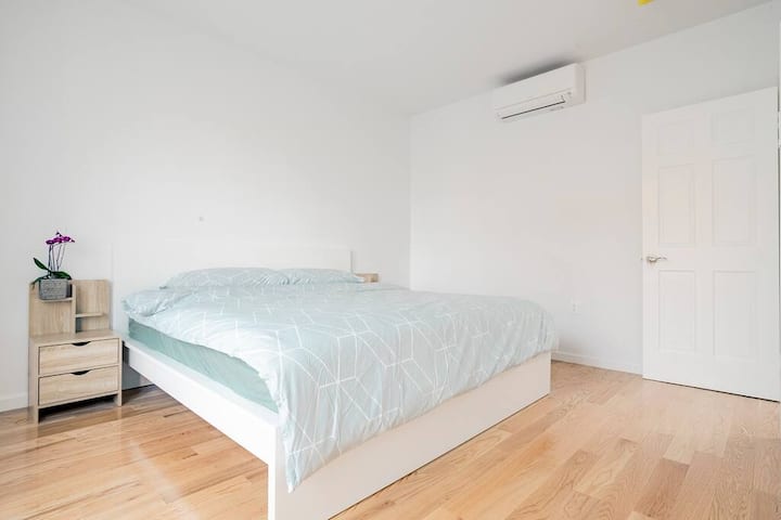 Bedroom with a platform bed and air conditioning