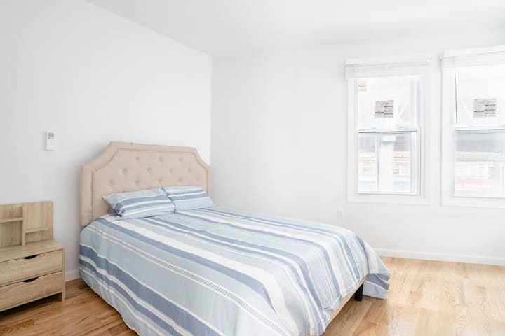 Bedroom with a king bed and windows