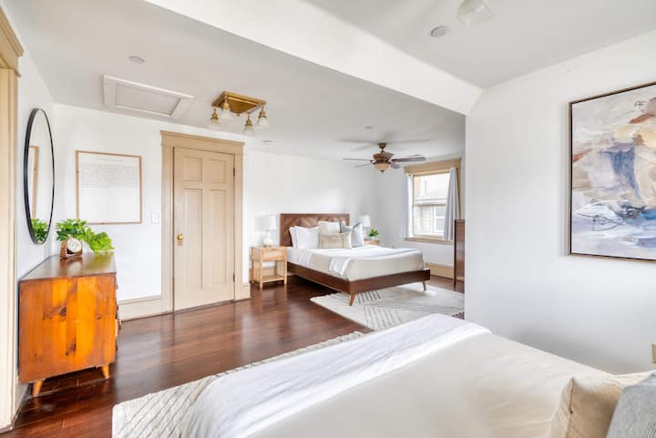 Bedroom with two beds, a dresser and closet.