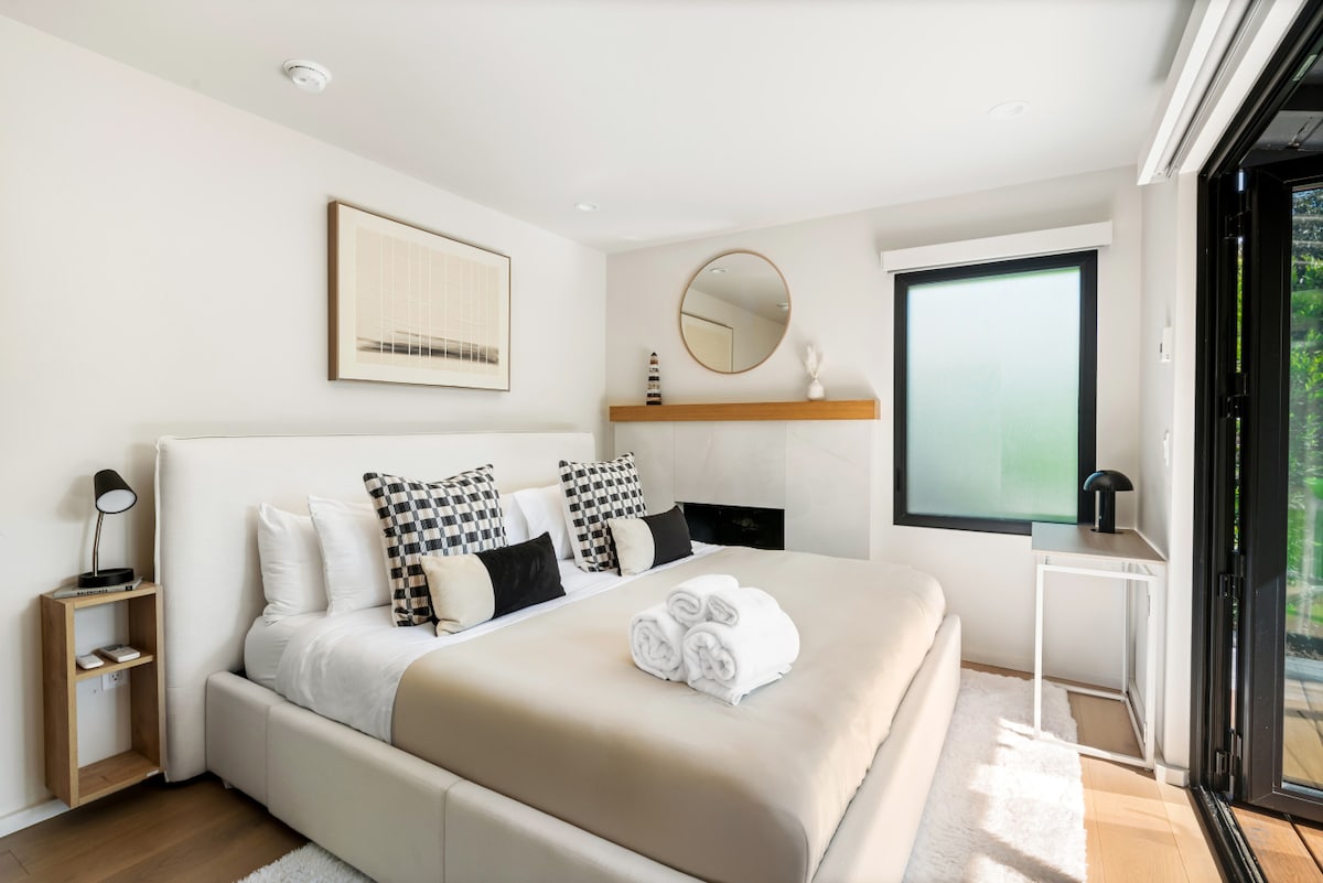 Unwind in the comfort of a bright and spacious bedroom featuring a king-sized bed, plush bedding, and fresh linens. The perfect spot to rest and recharge.