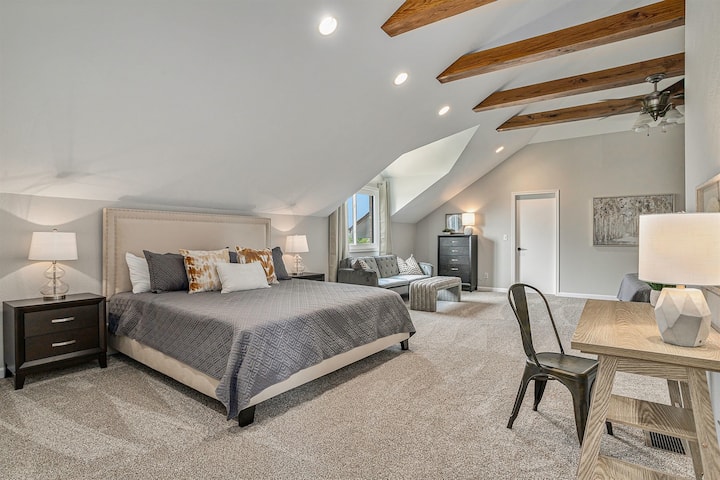 One of Two King Beds, Workspace, and Cozy Seating in Serene Master Bedroom