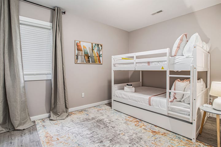 Our surf-themed room features full-over-full bunk beds with a trundle, perfect for families or groups. The room is thoughtfully decorated with surf-inspired decor, bringing a touch of the beach to your stay.