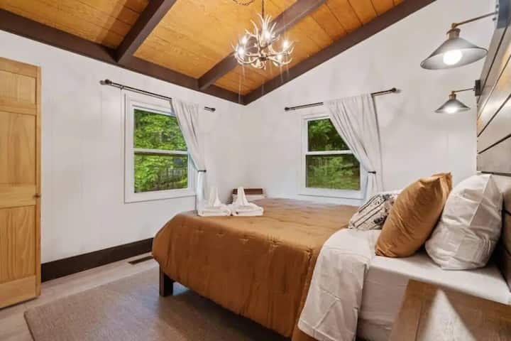 Mtazamo wa kisanii wa chandelier na msitu kutoka chumba cha pili cha kulala