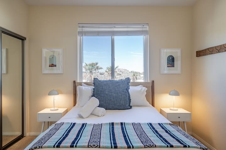 Drift off to dreamland in pure comfort with premium bedding, soft lighting, and desert-inspired decor. Wake up refreshed to embrace the beauty and exploration of Joshua Tree National Park!