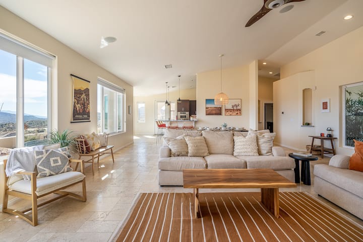 The luxurious living room at The Round Up is the epitome of desert comfort and style. Relax on the plush couches with a movie and snacks, play board games with friends, and bask in the warm glow of natural sunlight.
