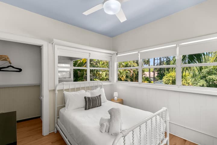 غرفة نوم كاملة مضاءة بأشعة الشمس مع خزانة