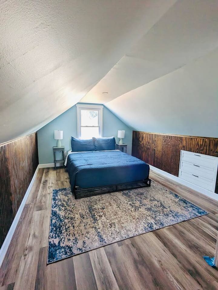 Second floor- The sunset room with a queen sized bed. Please note the slanted ceilings and the low profile bed frame.