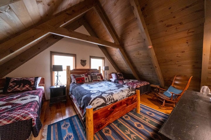 Upstairs Bedroom (two twins and a queen) with a walk-in closet, dresser, and TV.