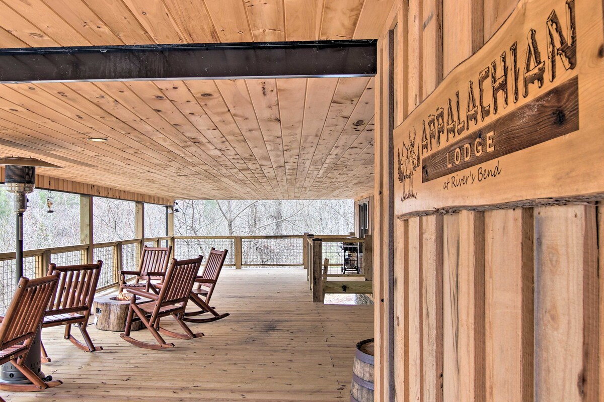 An outdoor deck area features several wooden rocking chairs arranged on a spacious wooden floor. Wood paneling and a rustic sign reading 'Appalachian Lodge' add to the inviting ambiance, while a tranquil natural setting is visible beyond the railing.