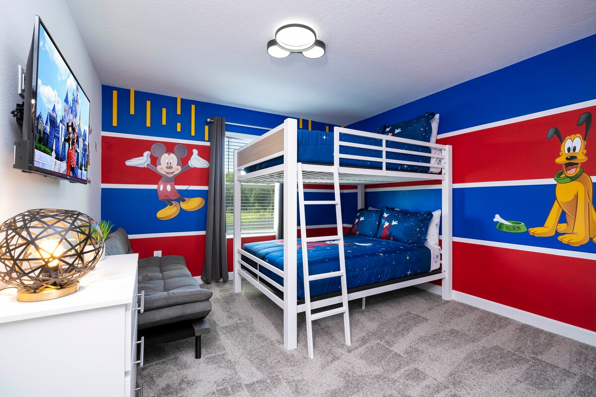Perfect for kids! This room boasts a magical Mickey Mouse theme and a full over full bunk bed for extra fun
