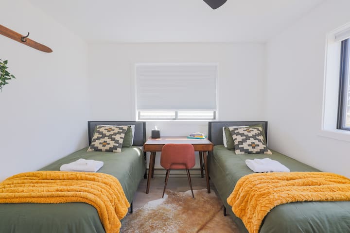 Მე-3 საძინებელში არის ორი ორადგილიანი საწოლი, კარადა, სამუშაო მაგიდა და ტეტონების ხედი.