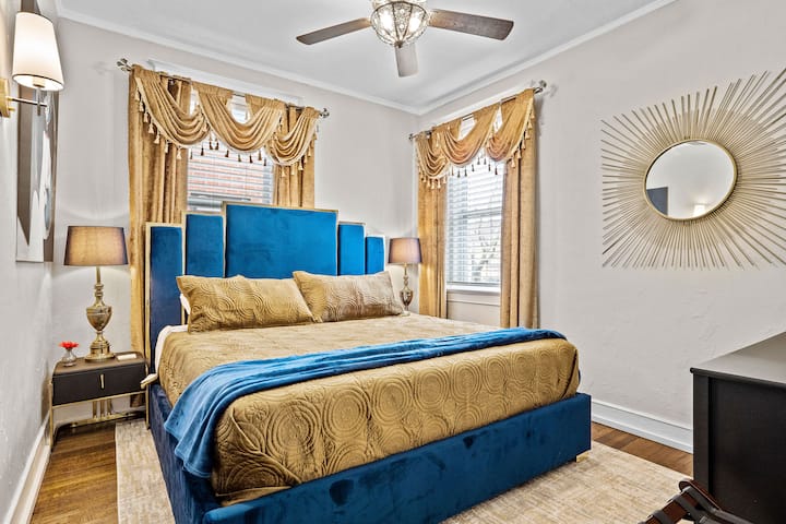 Slap af i et roligt soveværelse på et lavere niveau med en blød kingsize-dobbeltseng, en dristig sengegavl i velour, smart-tv og vintageguldgardiner – et elegant fristed i Midtown Kansas City.