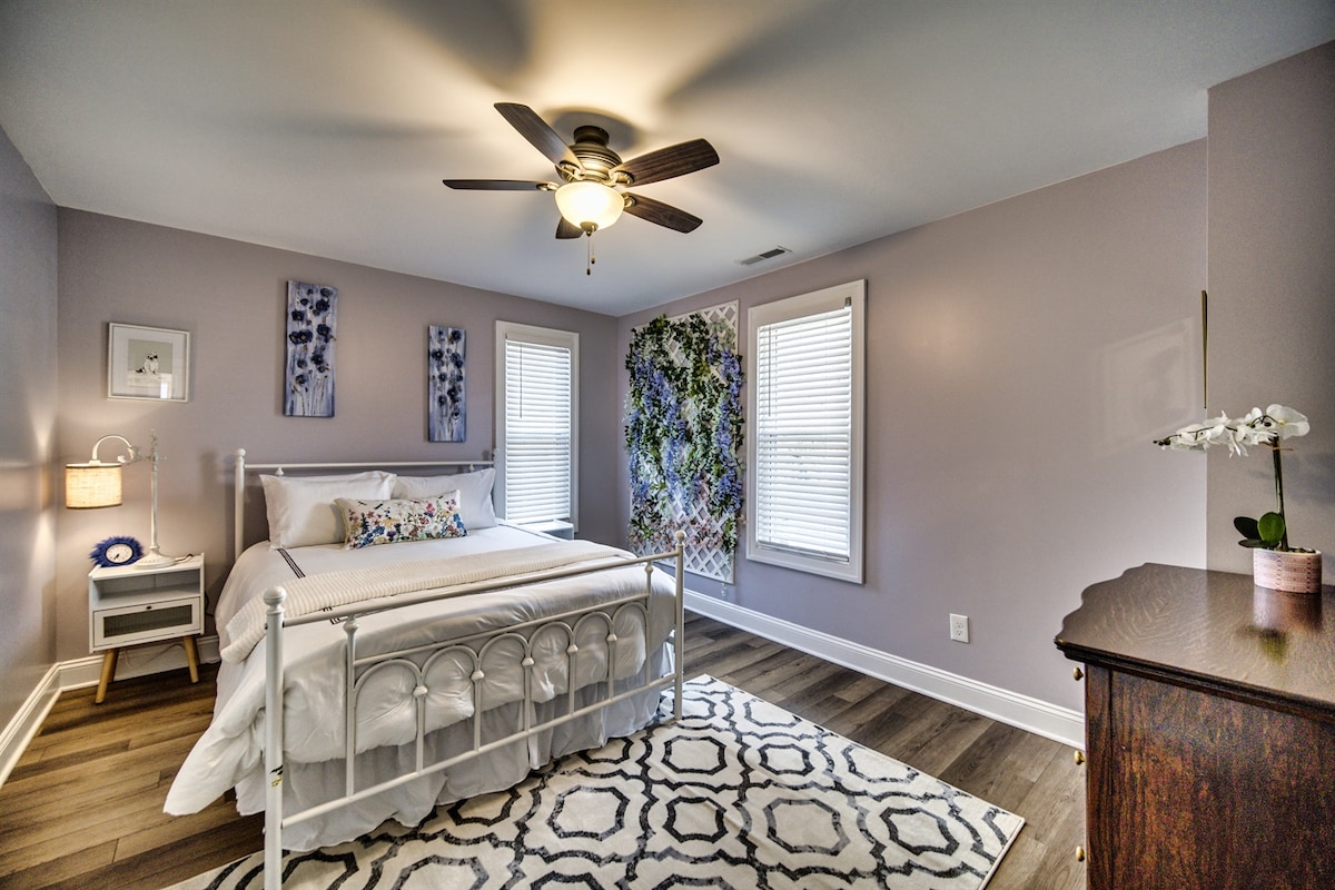 Lavender Room features a faux garden wall with wisteria and vines and an antique dresser that was restored.